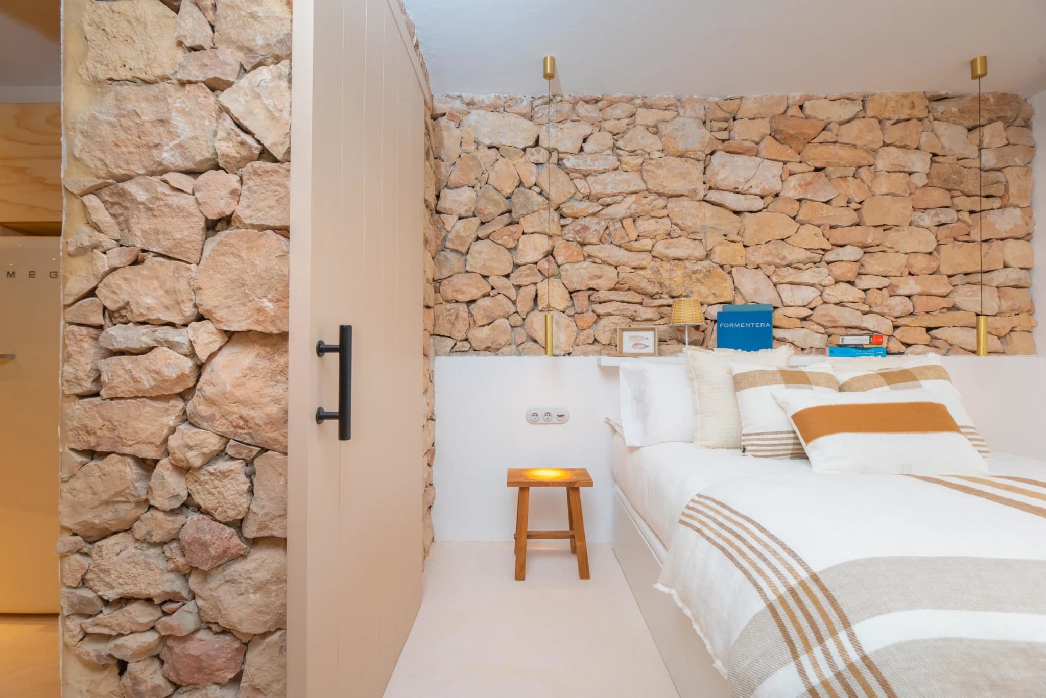 Bedroom with exposed stone wall