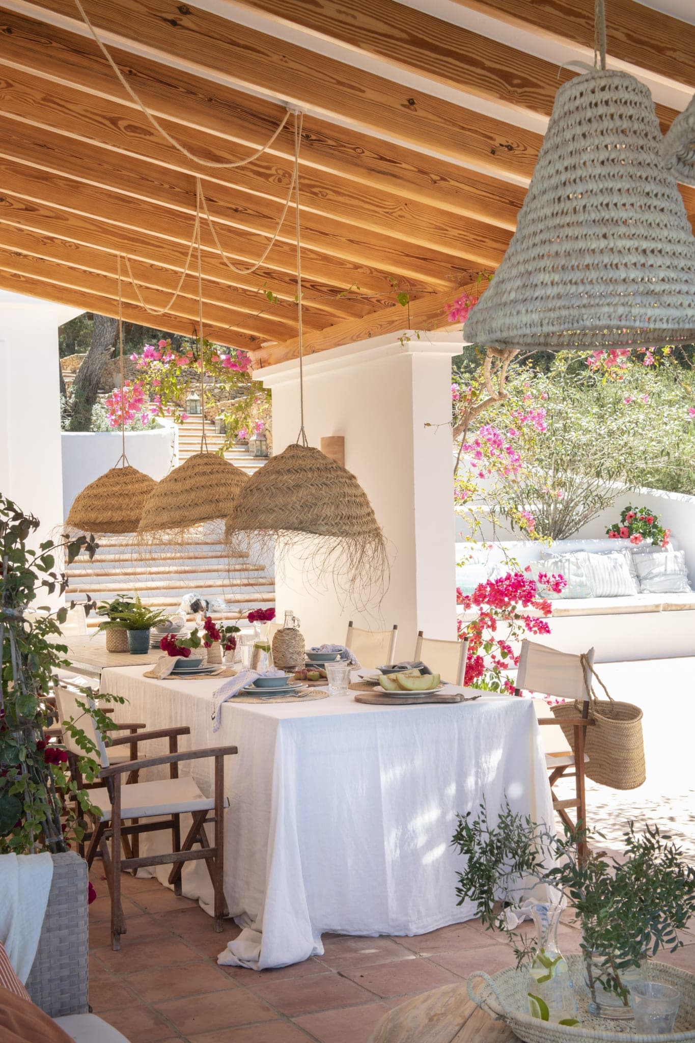 Dining terrace hung with bougainvillea